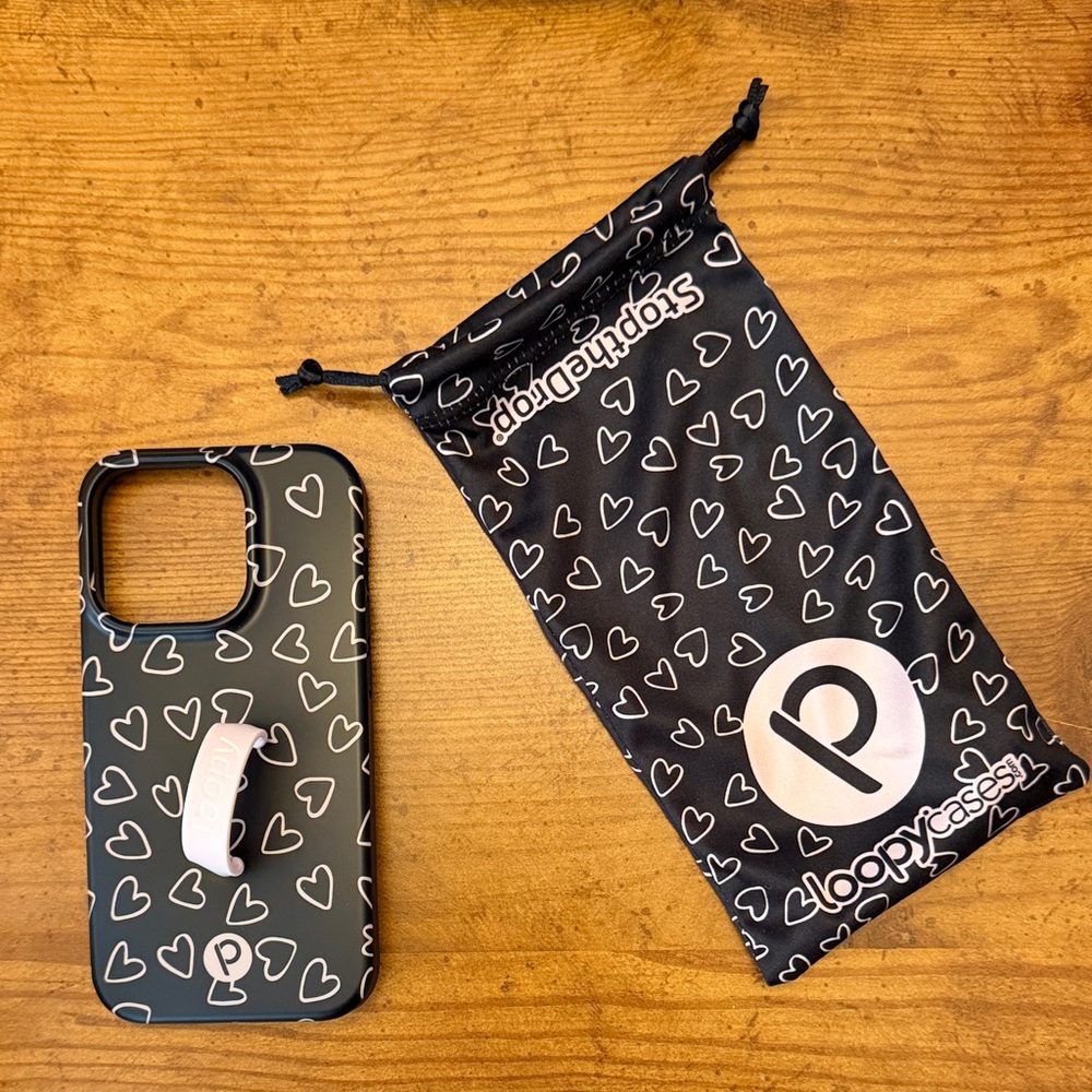 Black Loopy case with pink hearts.  iPhone 14 Pro.